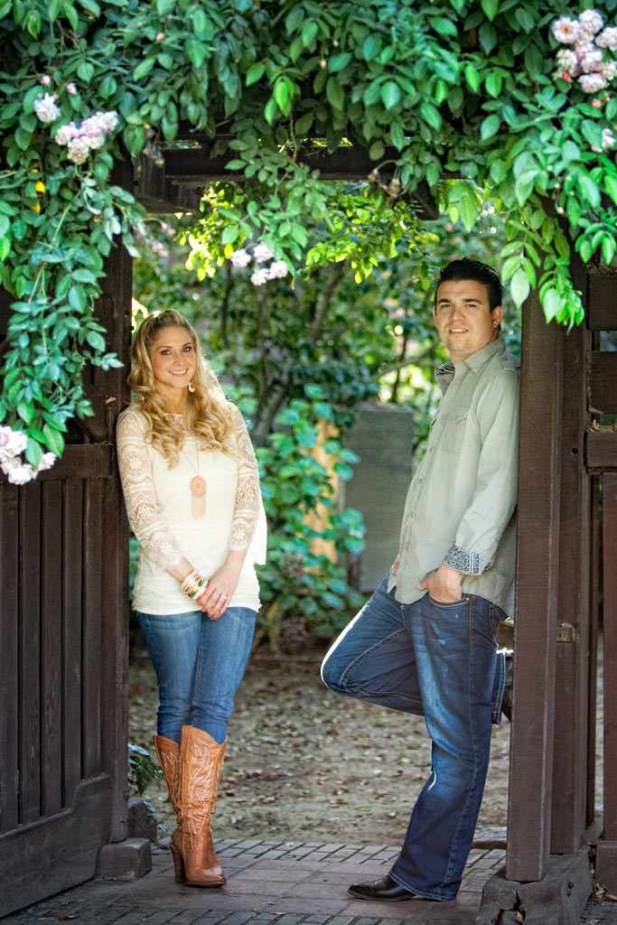 Engaged couple standing in a gate