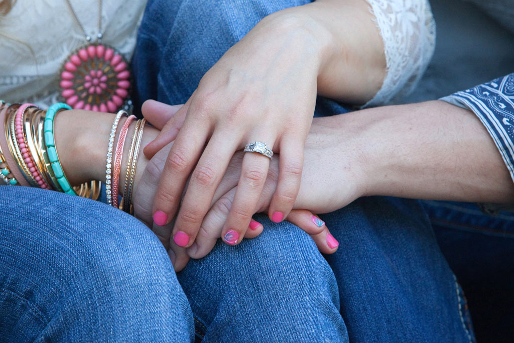Young engaged couple holding hands