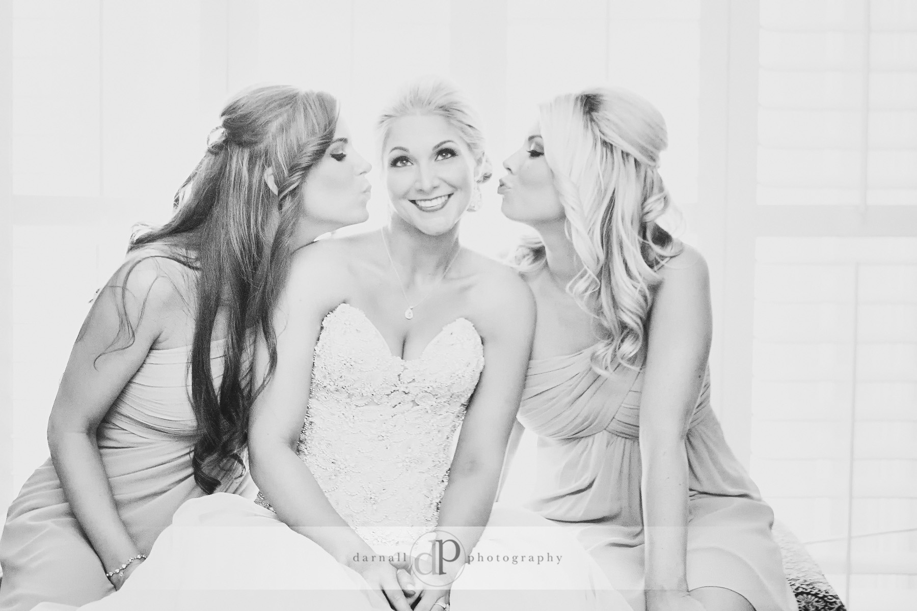 Bridesmaids kissing bride picture